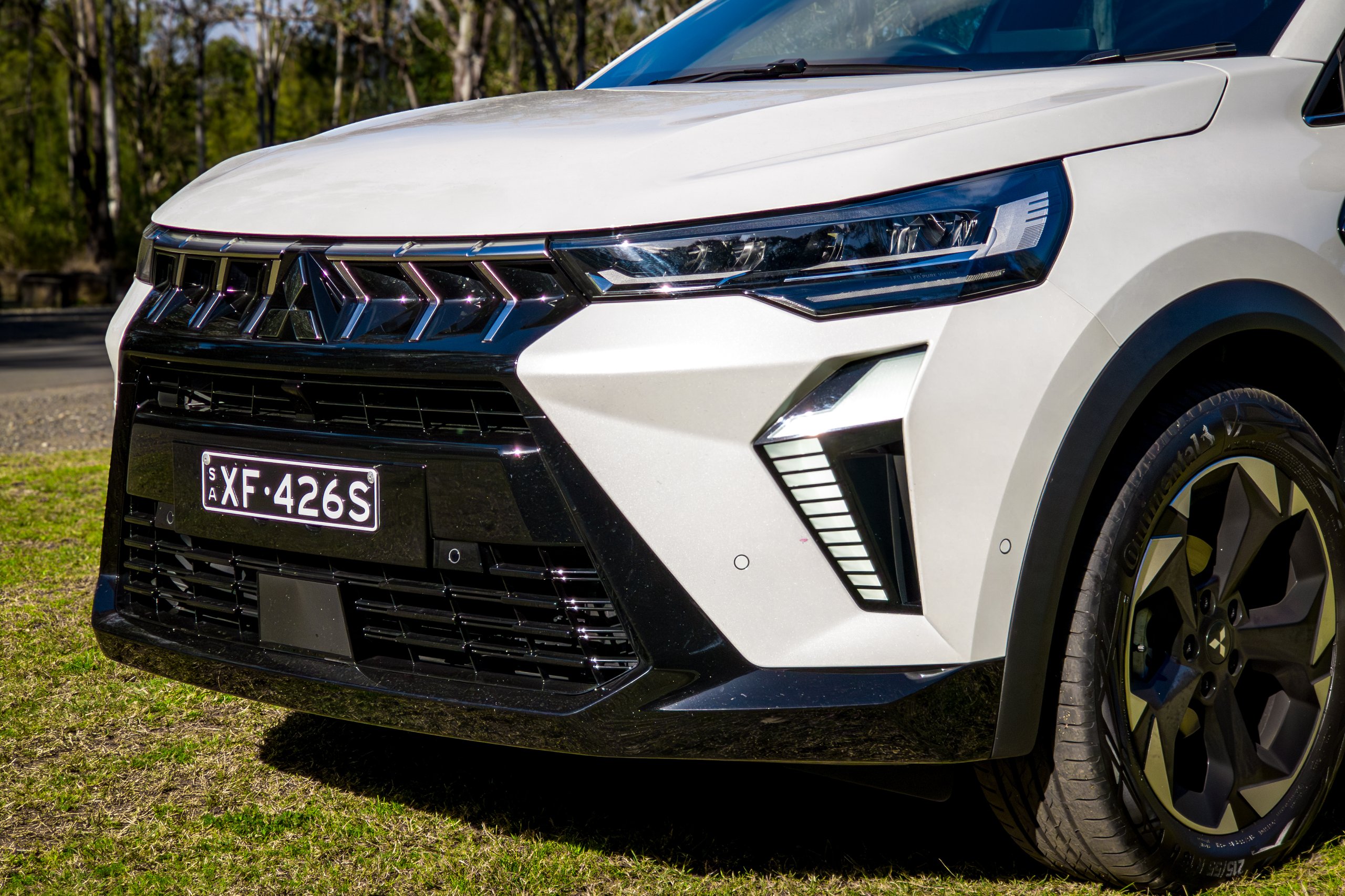 Close-up of the 2026 Mitsubishi ASX Aspire grille, LED headlight and vertical daytime running light