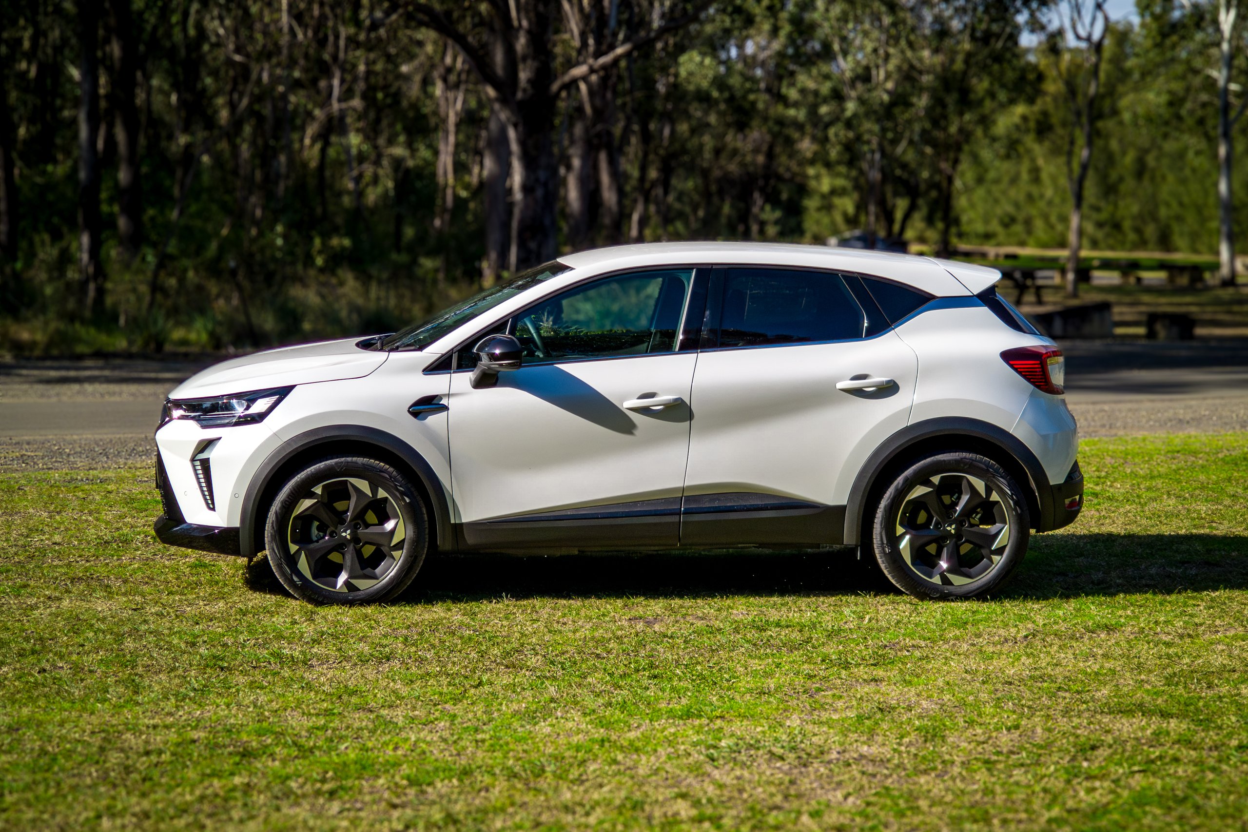 Crystal White 2026 Mitsubishi ASX Aspire side profile parked beside a bushland picnic area