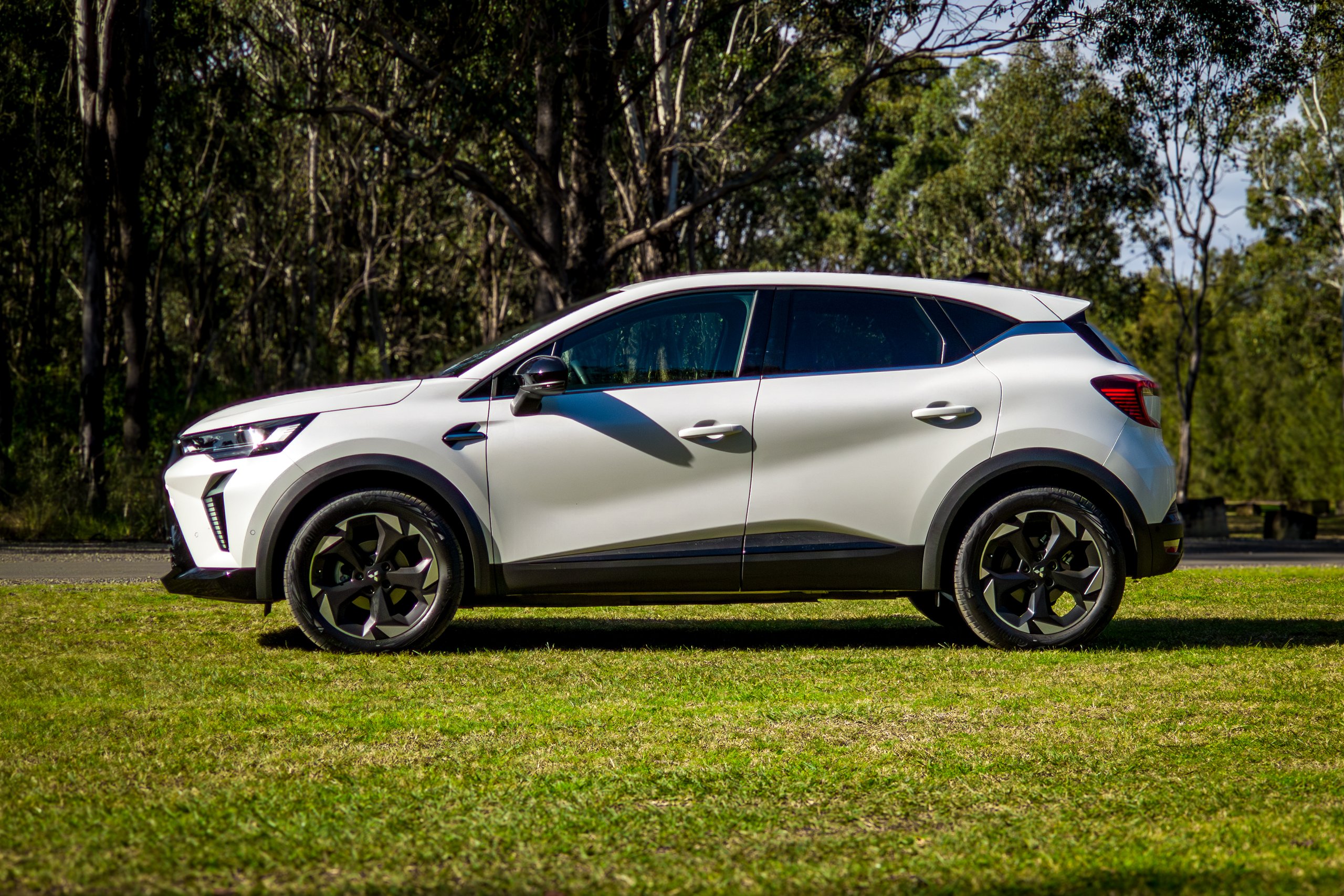 Crystal White 2026 Mitsubishi ASX Aspire full side profile from the passenger side on grass