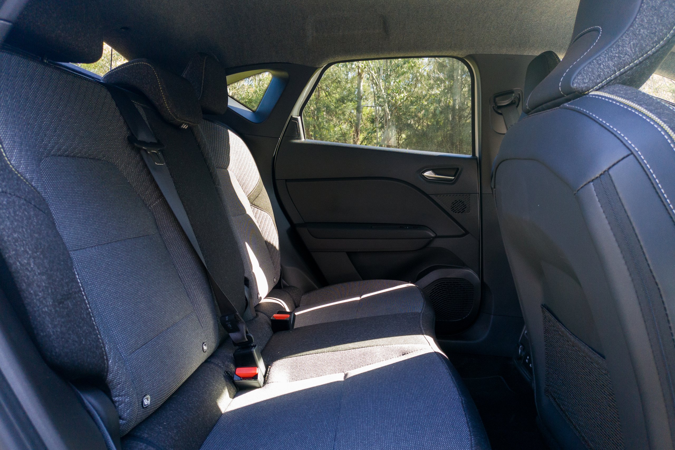 Rear seats of the 2026 Mitsubishi ASX Aspire in dark patterned cloth with folding armrest